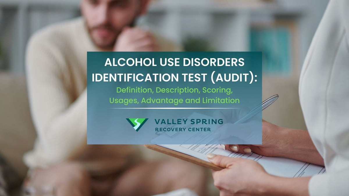 Clinician administering the AUDIT alcohol screening questionnaire beside the Valley Spring Recovery Center logo