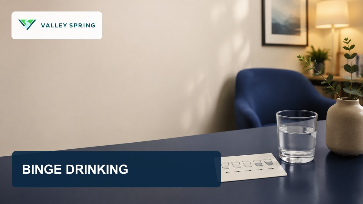 Branded binge drinking article hero showing a glass of water and a blank self-check card in a quiet room
