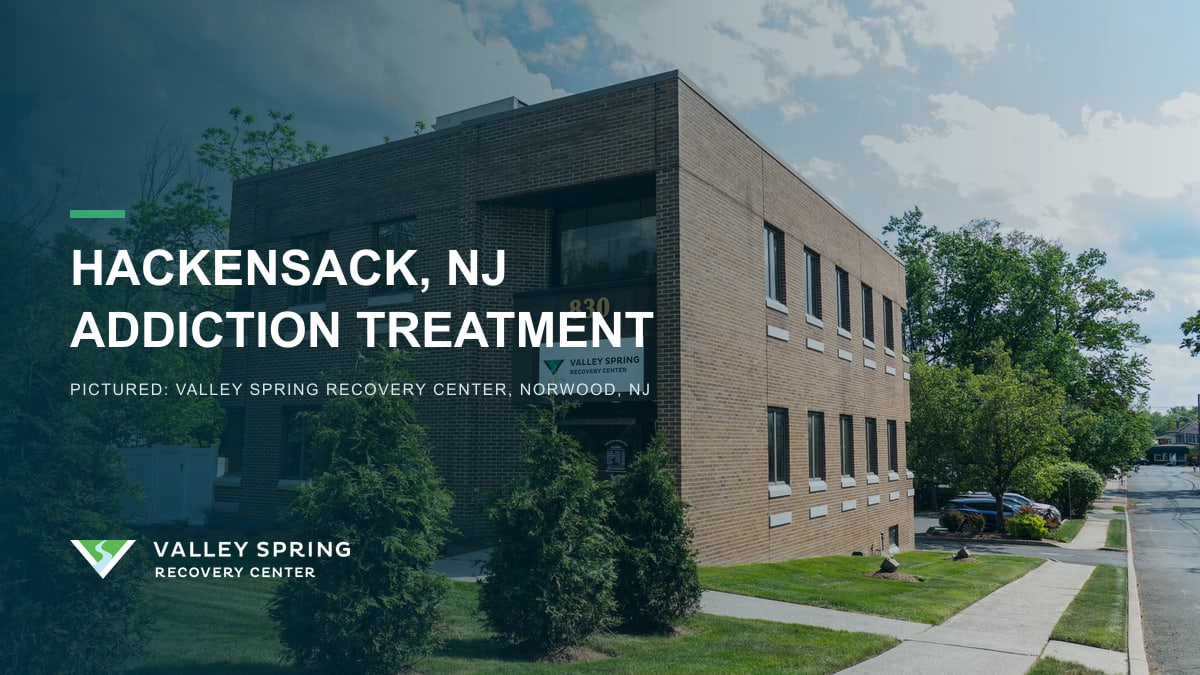 Corner view of the brick Valley Spring Recovery Center building in Norwood, New Jersey, branded for Hackensack residents seeking addiction treatment