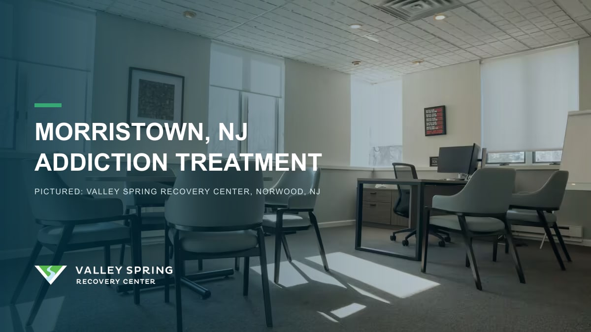 Meeting room with round tables and gray chairs inside Valley Spring Recovery Center in Norwood, New Jersey, branded for Morristown addiction treatment access Meeting room with round tables and gray chairs inside Valley Spring Recovery Center in Norwood, New Jersey, branded for Morristown addiction treatment access
