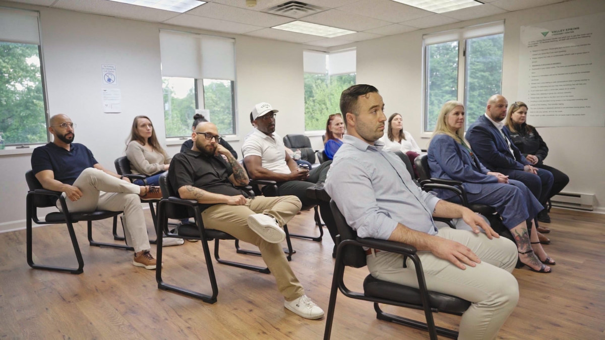 Guests listening together at a Valley Spring Recovery Center event