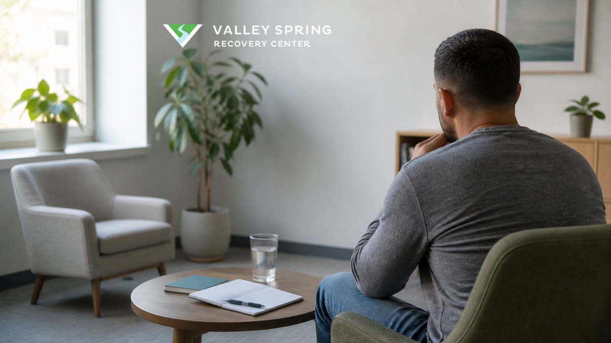 Adult seated in a counseling room with a notebook and recovery plan before discussing a return to substance use