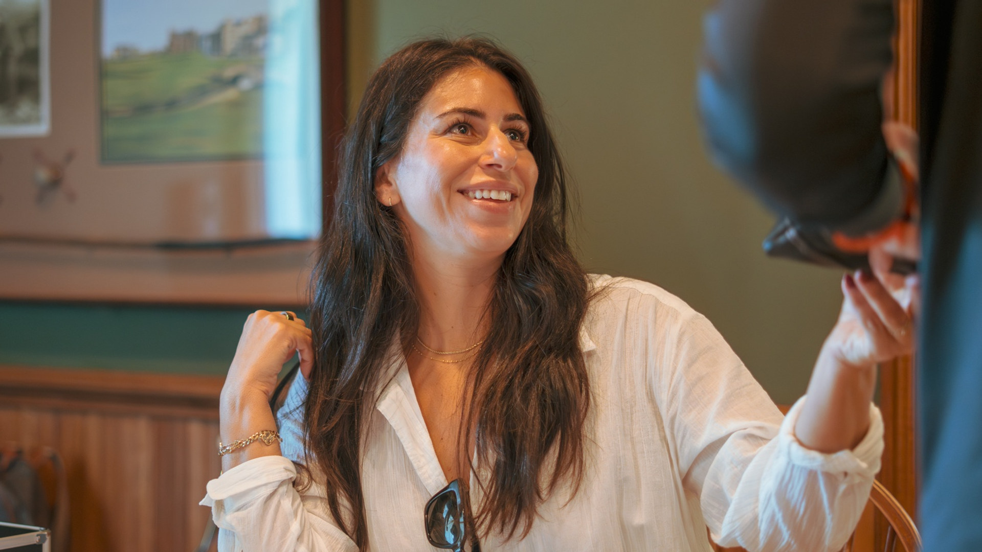 Lisa Siclari, Director of Education and Clinical Partnerships at Valley Spring Recovery Center, smiling while seated at an event table