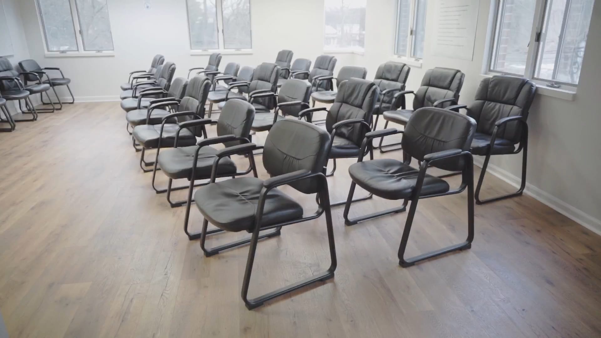 Evening group room at Valley Spring Recovery Center in Norwood, New Jersey, set with leather armchairs in rows facing the front