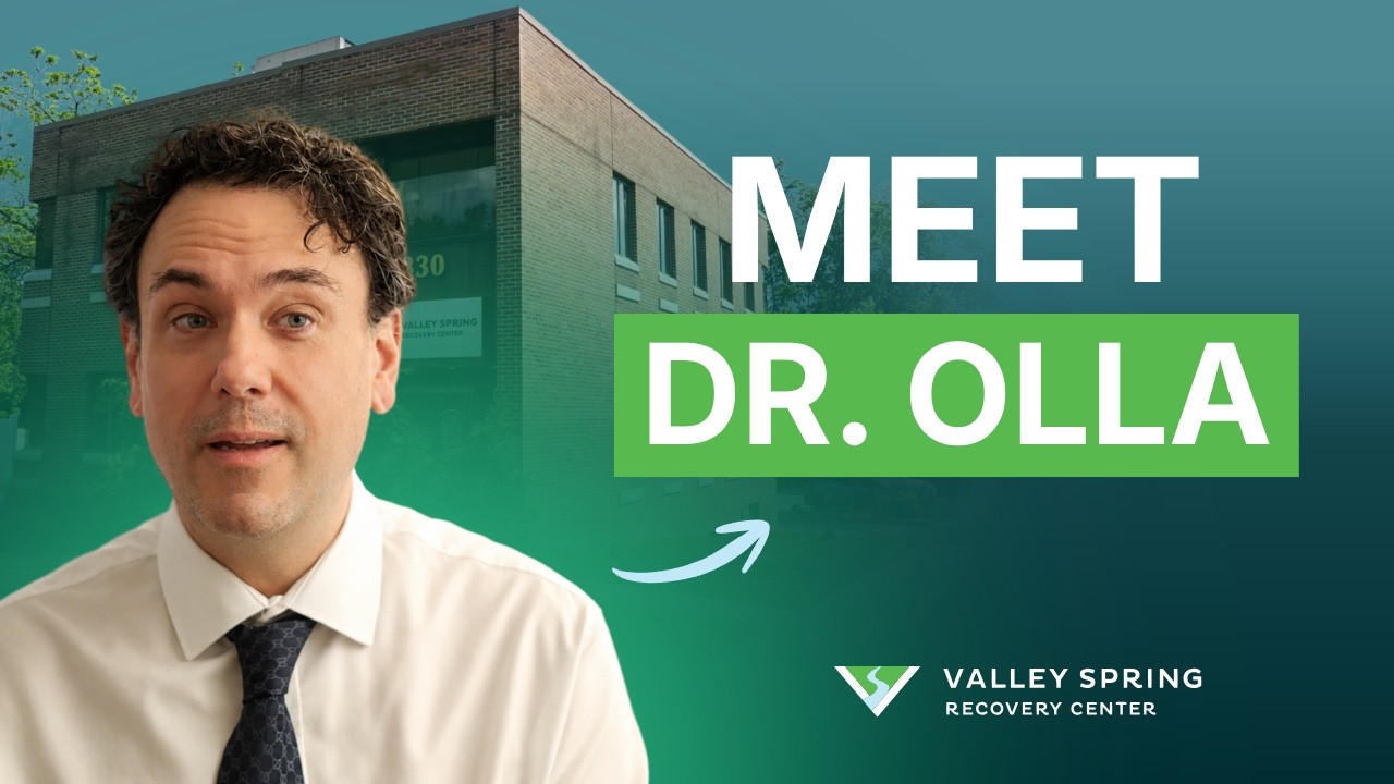 Dr. Michael Olla in front of the Valley Spring Recovery Center building beside the words Meet Dr. Olla