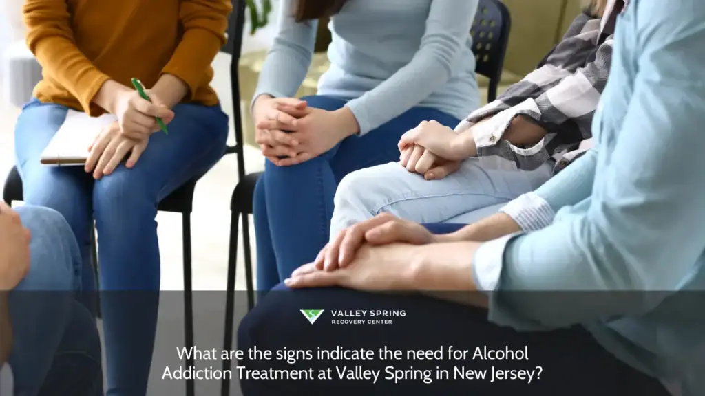 Participants in a group therapy session at Valley Spring in New Jersey, engaged in discussion about signs indicating the need for alcohol addiction treatment.