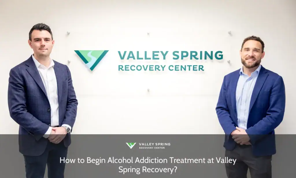 Two professionals stand confidently beside the Valley Spring Recovery Center sign, reflecting their commitment to alcohol addiction treatment.