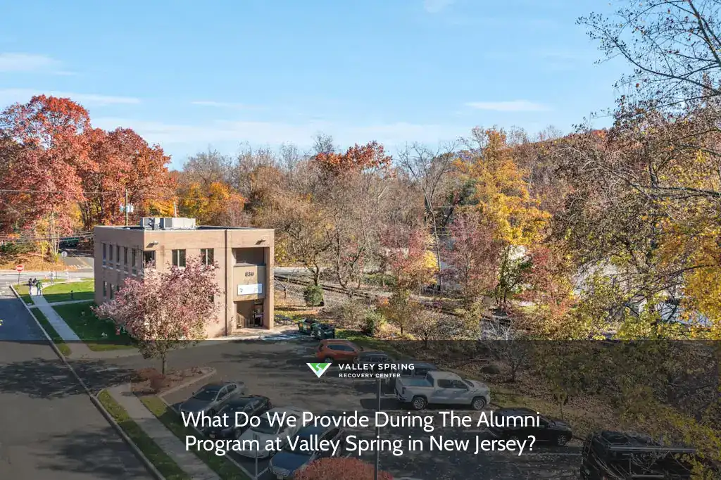 Valley Spring facility in New Jersey, showcasing autumn foliage, parking area, and visitors approaching the entrance during the Alumni Program.
