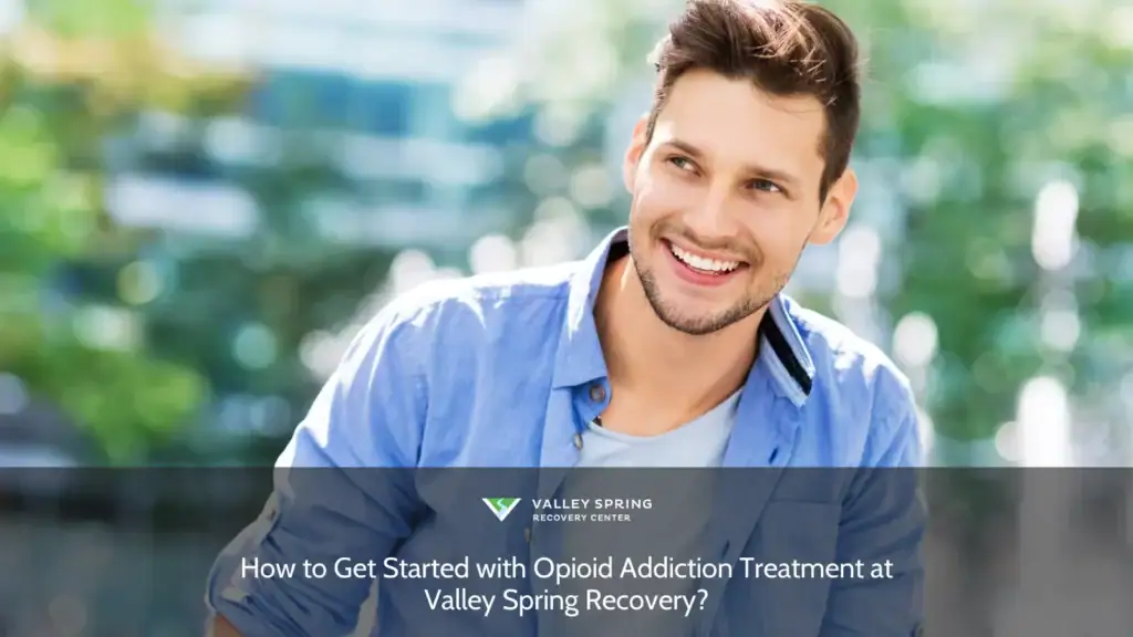 Smiling young man in a blue shirt outdoors, exemplifying joy and positivity, suitable for discussions on wellness and personal growth.