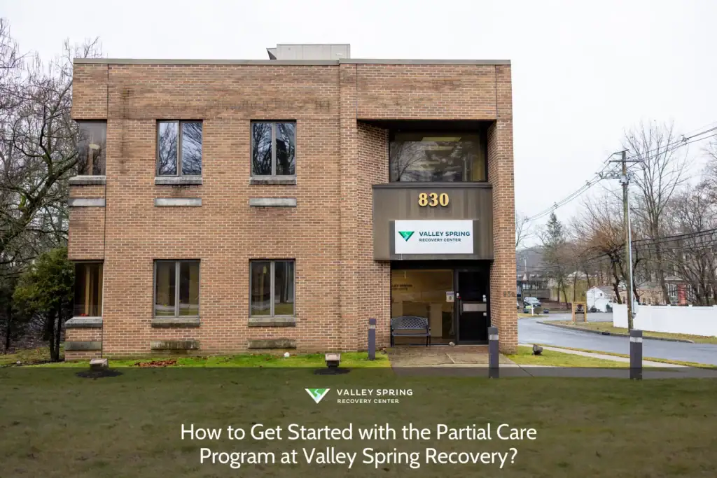 Valley Spring Recovery Center's brick building features large windows, a welcoming entrance, and clear signage at 830, inviting visitors to learn about the program.